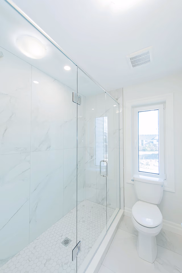 Marble-look porcelain shower walls, the lakeside house