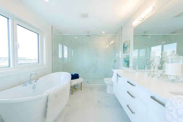 Ensuite with a freestanding bath and marble-look porcelain walls