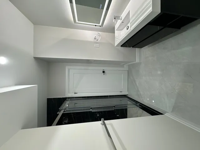 Ensuite with a floating white vanity and a black porcelain shower