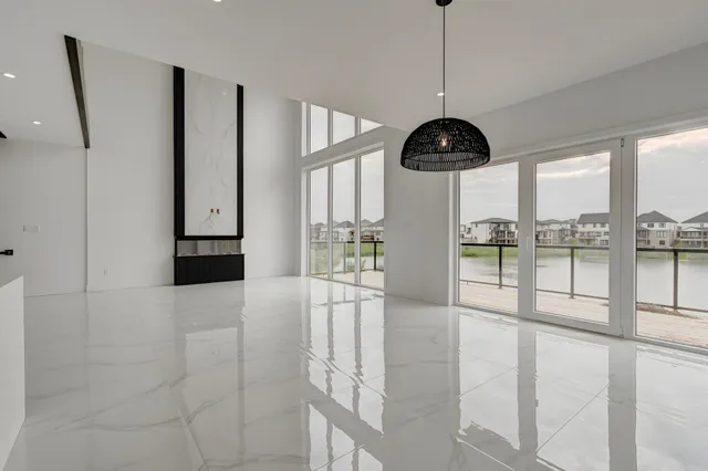 Great room with a polished porcelain floor and a black dome pendant