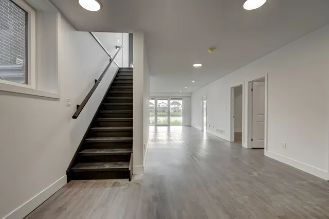 Open-riser stair with dark treads over grey plank flooring, 2190 Tokala Trail